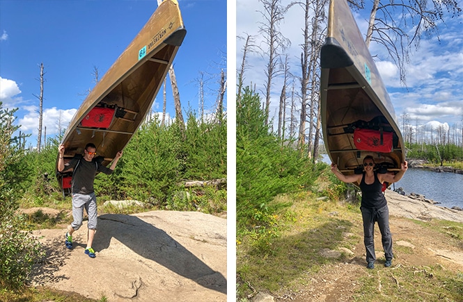 man and woman carrying a canoe portaging at Boundary Waters Canoe Area Wilderness