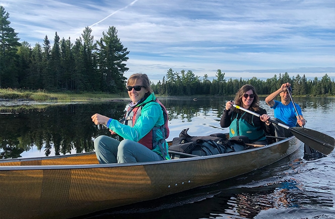 Paddlers in a canoe in a lake at Boundary Waters Canoe Area Wilderness