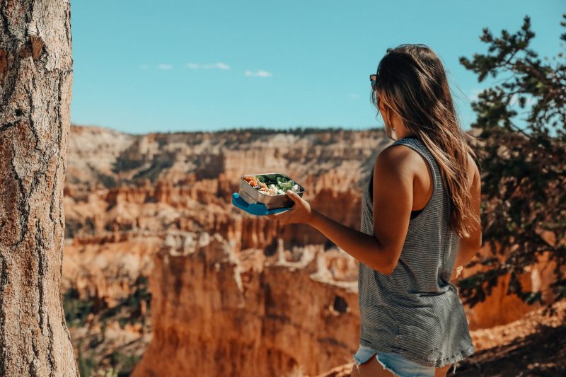 girl hiking with reusable lunch box